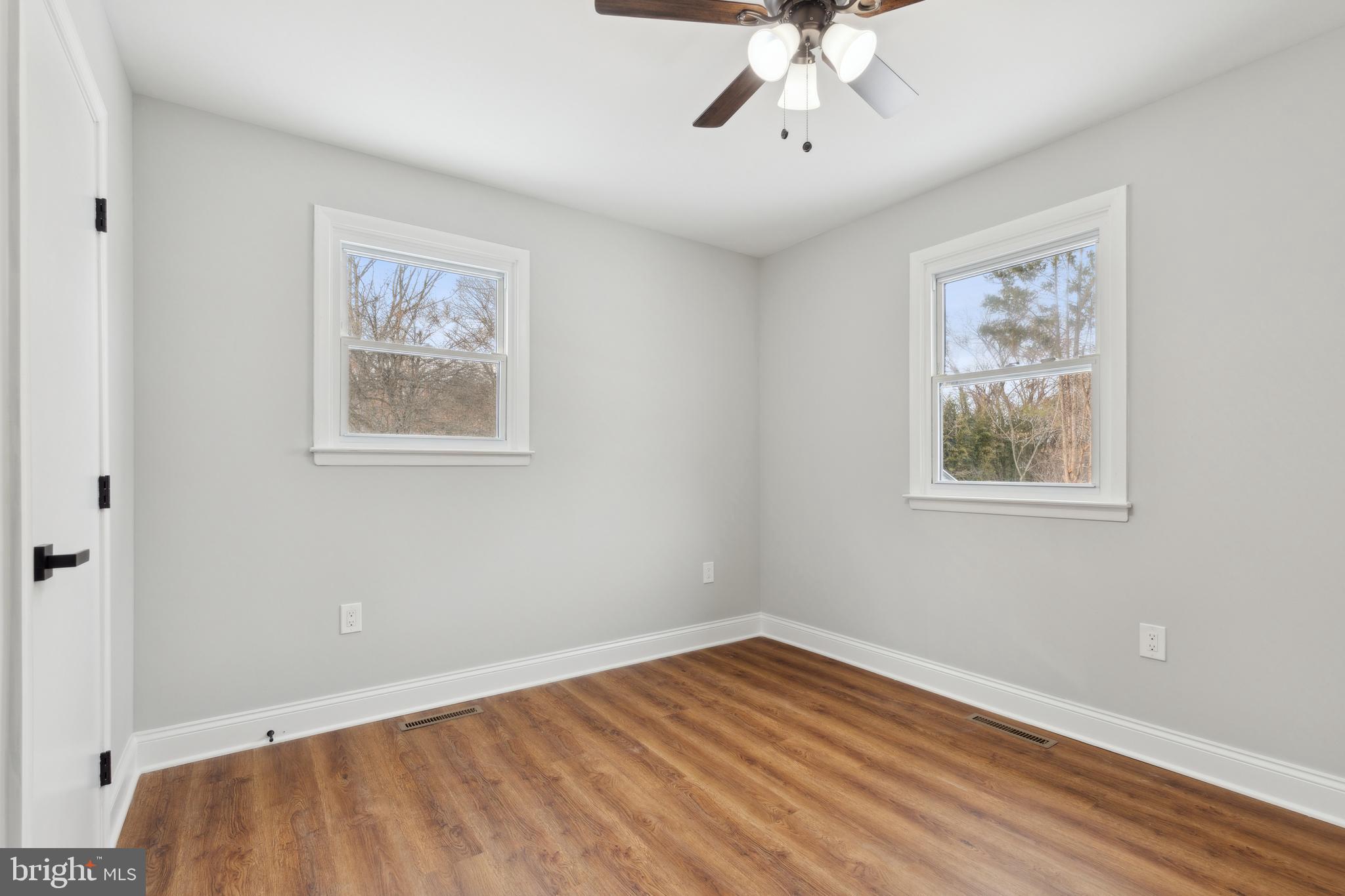7760 Telegraph Road Severn, MD 21144 - Photo 28 of 49 a view of an empty room with a window and wooden floor