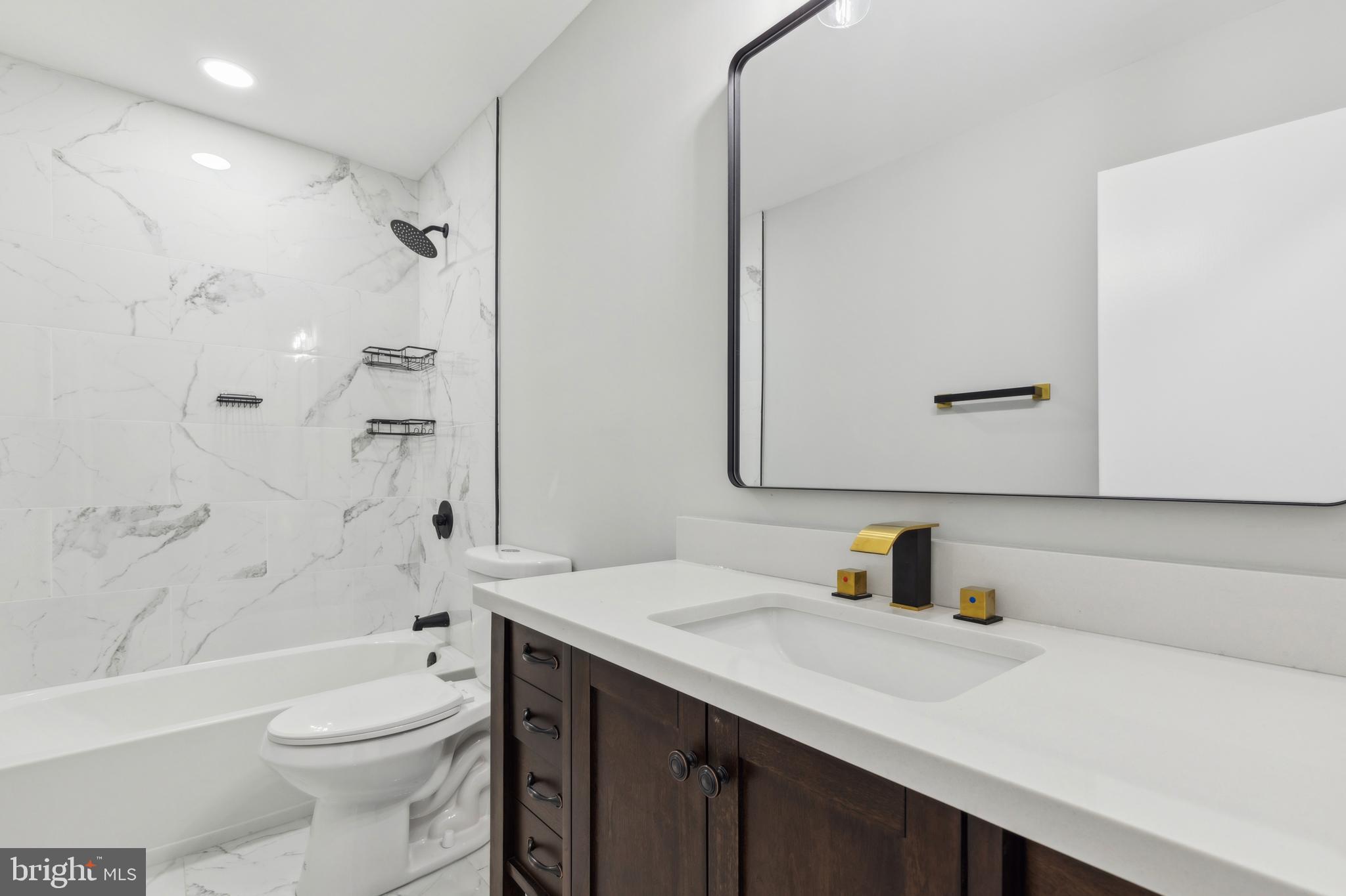 7760 Telegraph Road Severn, MD 21144 - Photo 32 of 49 a bathroom with a sink a toilet and shower