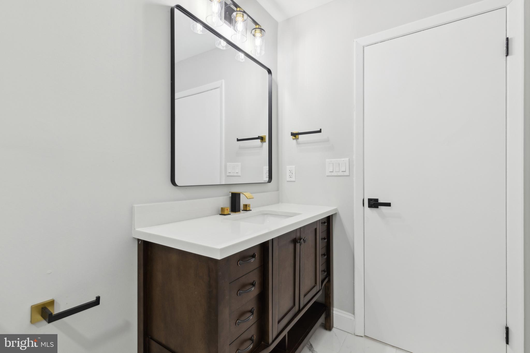 7760 Telegraph Road Severn, MD 21144 - Photo 33 of 49 a bathroom with a sink and a mirror