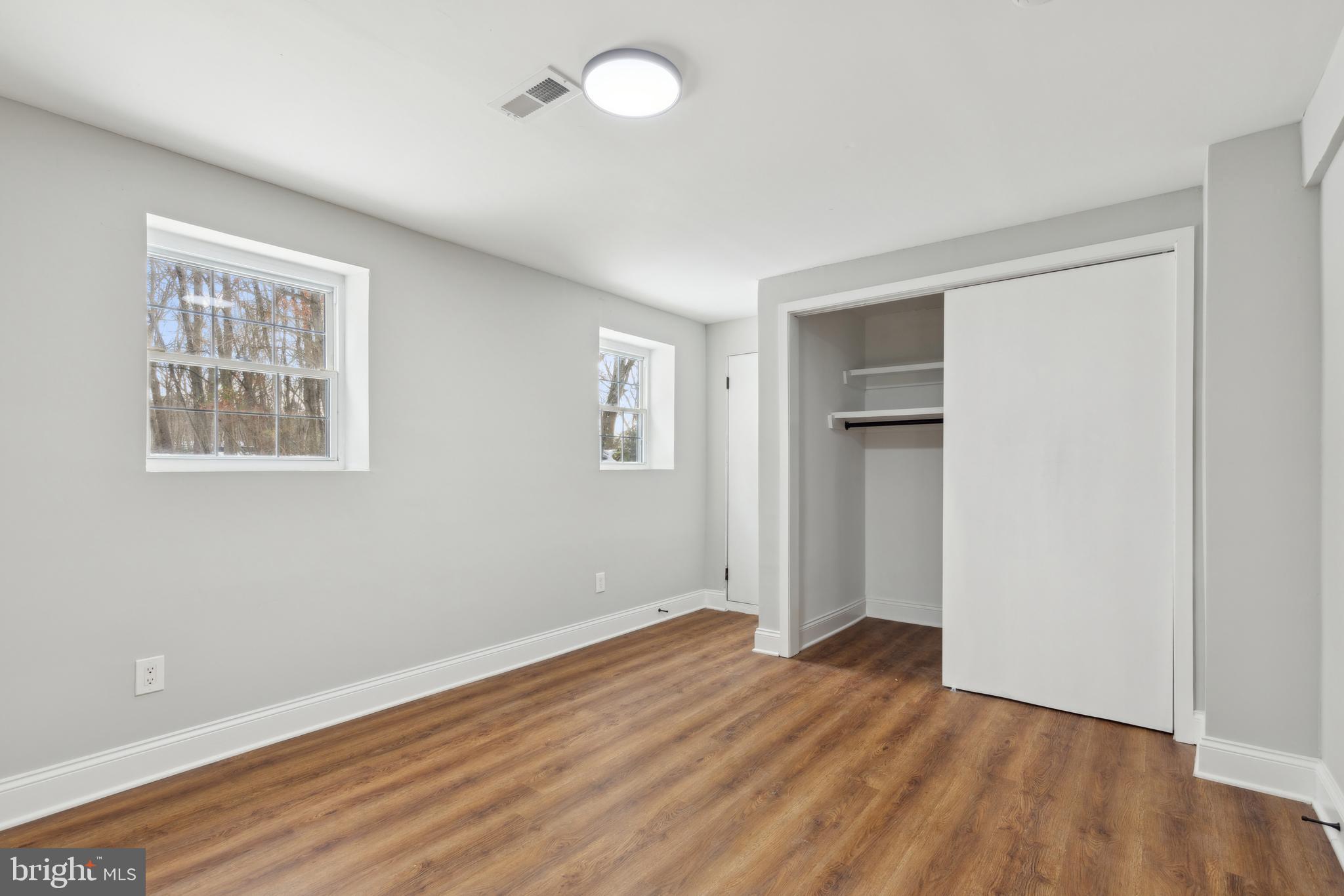 7760 Telegraph Road Severn, MD 21144 - Photo 41 of 49 an empty room with wooden floor and windows