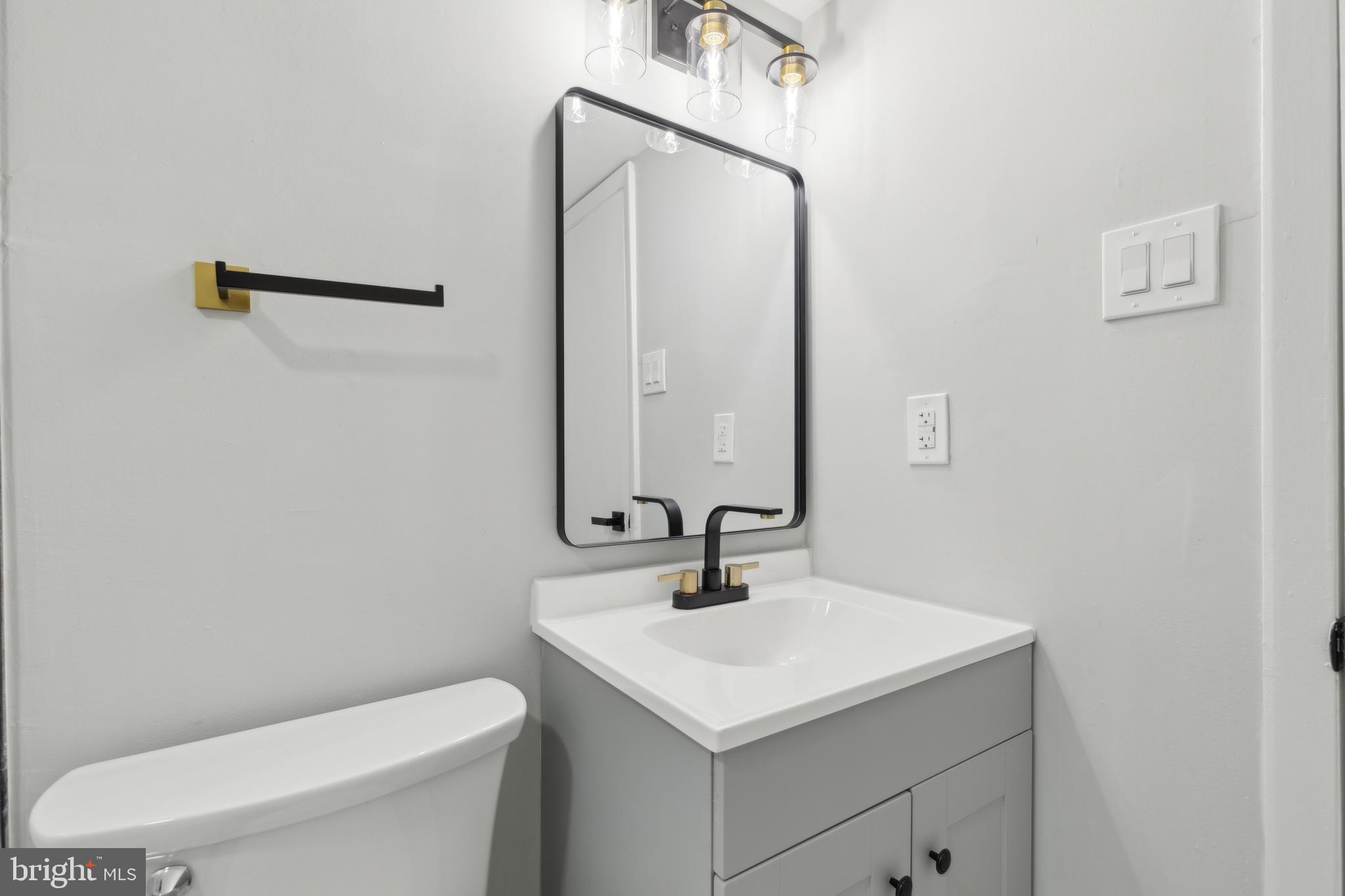 7760 Telegraph Road Severn, MD 21144 - Photo 44 of 49 a bathroom with a sink a toilet and mirror