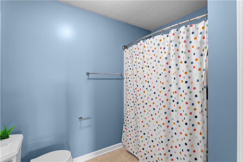 237 Morning Grove Lane Valencia, PA 16059 - Photo 32 of 50 a bathroom with a toilet and a shower curtain