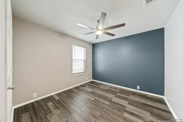 a view of room with window and ceiling fan