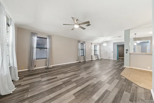 a view of livingroom with hardwood floor and ceiling fan