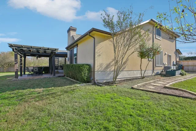 an aerial view of a house with a yard basket ball court