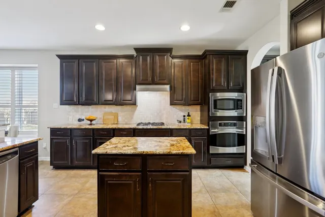a kitchen with a refrigerator and a sink