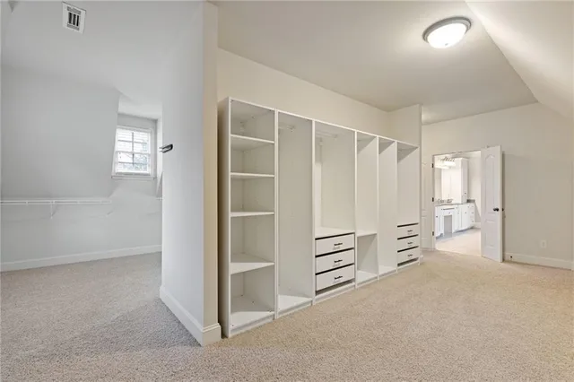 a bathroom with a granite countertop bathtub shower sink vanity and toilet