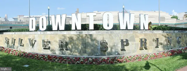 a view of outdoor space with a garden and signage