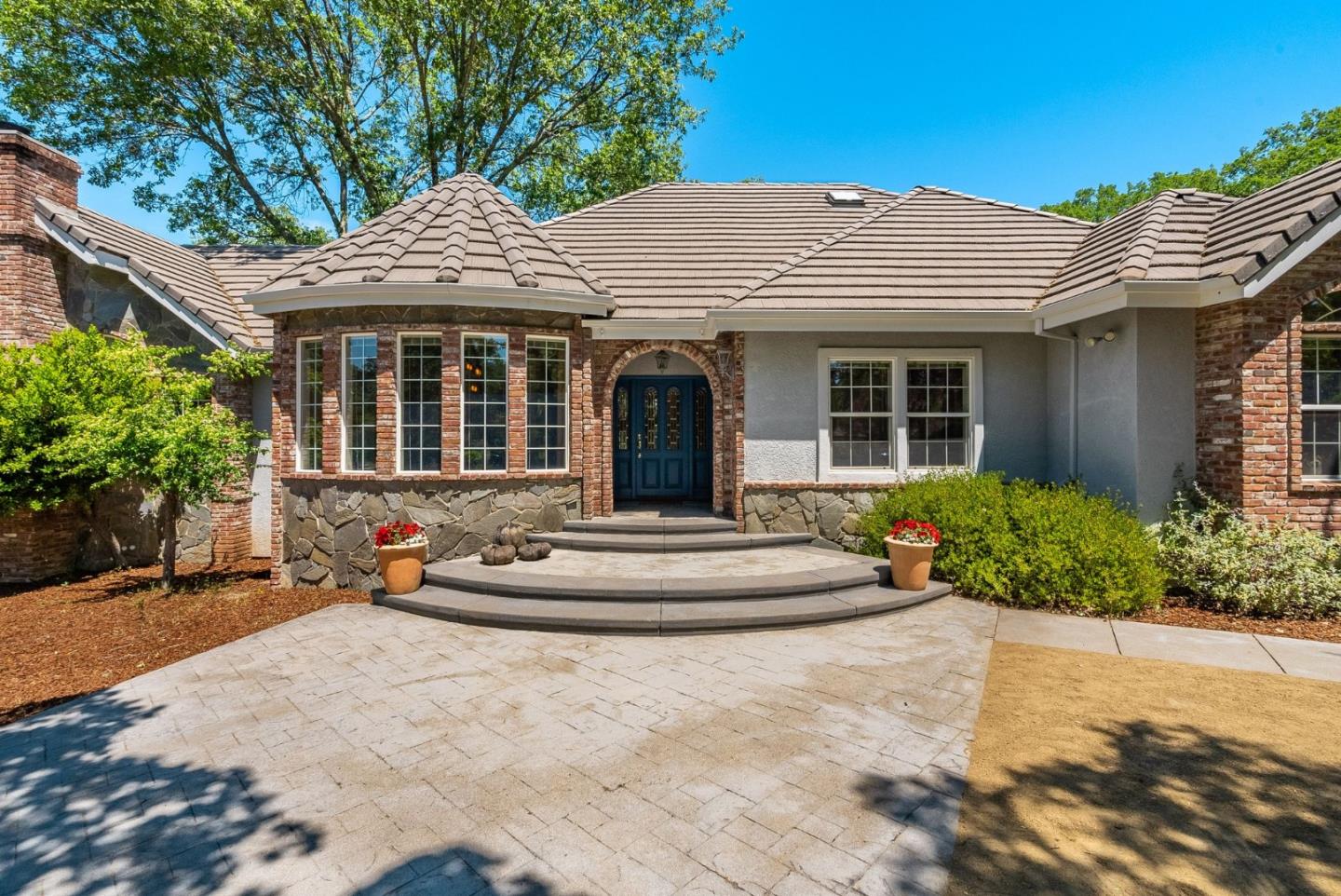 5431 Milton Ranch Road Shingle Springs, CA 95682 - Photo 15 of 57 a view of a white house with large windows and potted plants