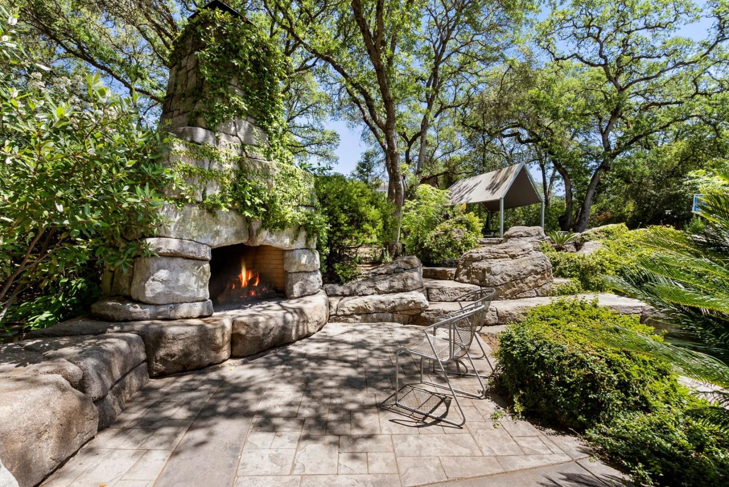 5431 Milton Ranch Road Shingle Springs, CA 95682 - Photo 8 of 57 a view of a chairs and fire pit in a backyard