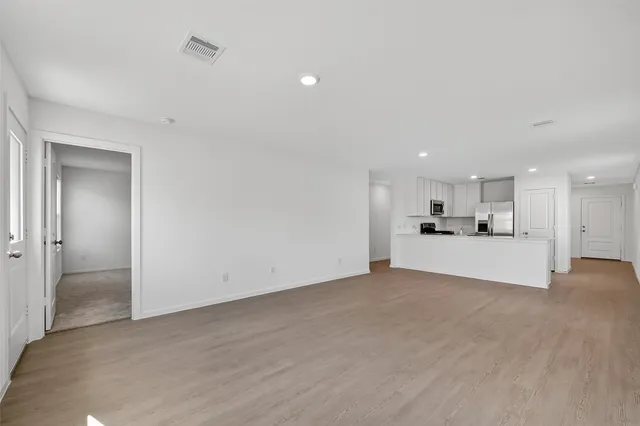 a view of kitchen with kitchen island and wooden floor