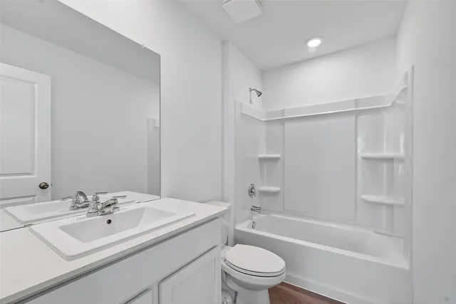 a bathroom with a sink a toilet and bathtub