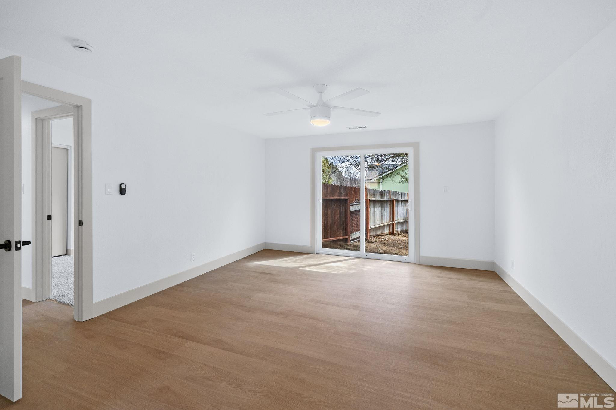 3575 Gull Street Reno, NV 89508 - Photo 17 of 32 an empty room with windows and chandelier fan