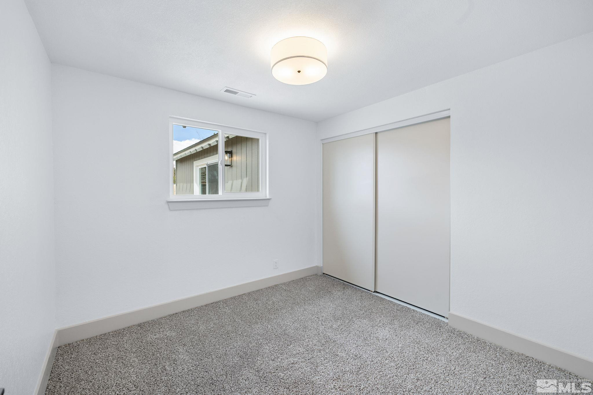 3575 Gull Street Reno, NV 89508 - Photo 23 of 32 an empty room with windows and closet