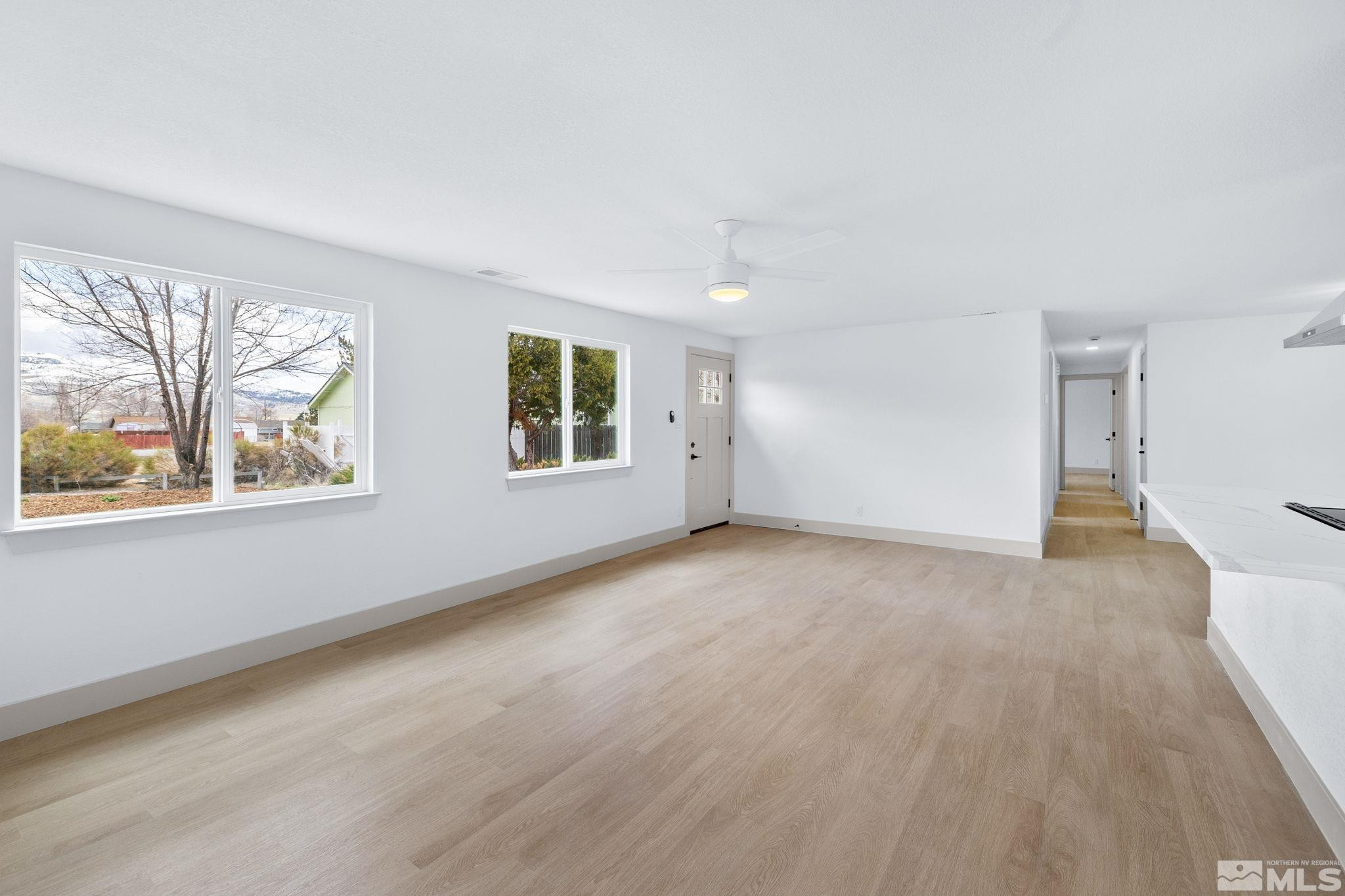 3575 Gull Street Reno, NV 89508 - Photo 5 of 32 a view of an empty room with wooden floor and windows