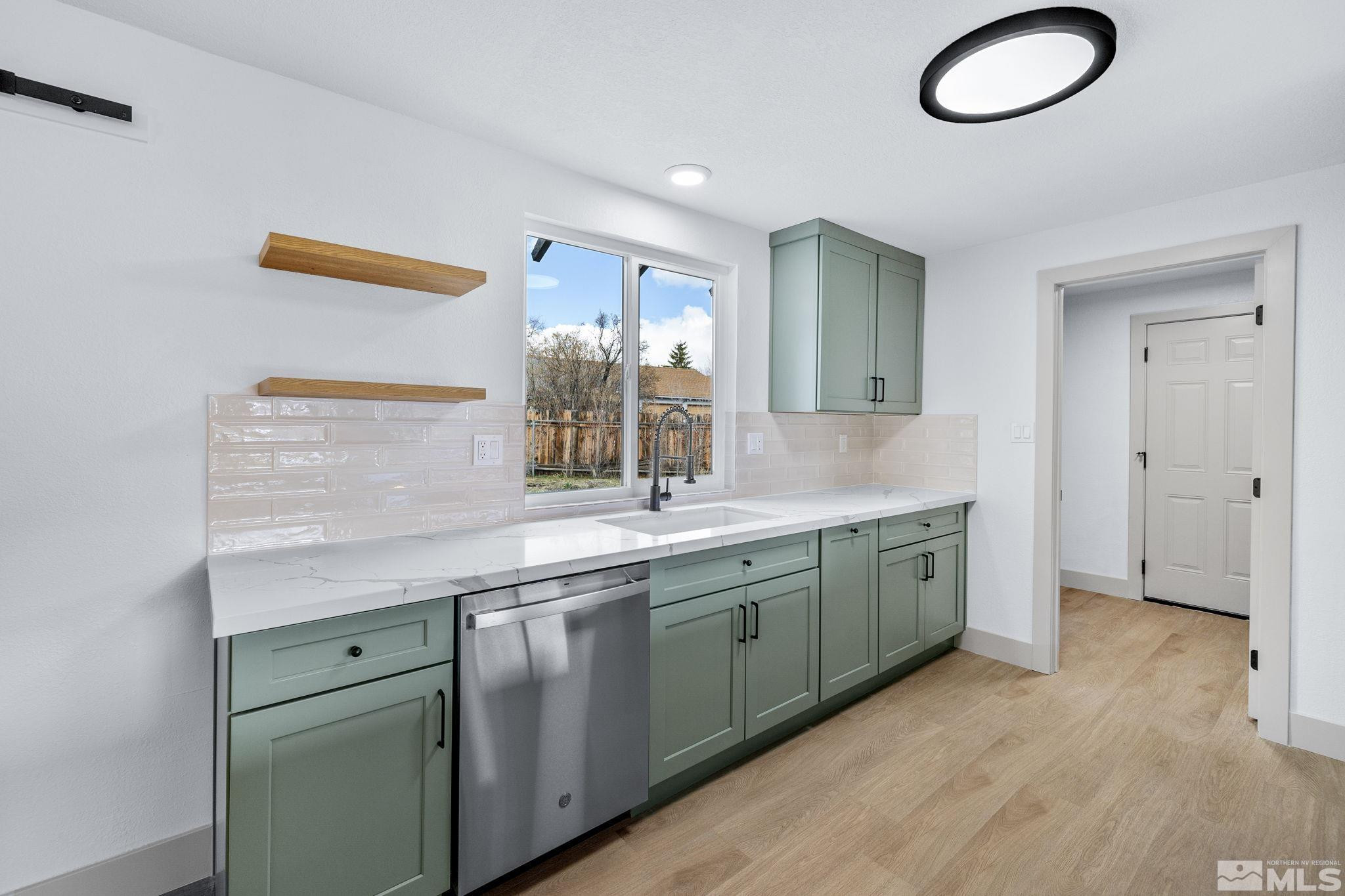 3575 Gull Street Reno, NV 89508 - Photo 8 of 32 a spacious bathroom with a granite countertop sink a mirror and a