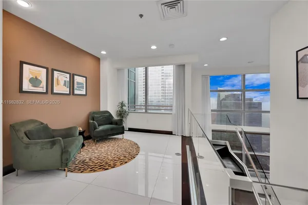 a living room with furniture rug and wooden floor