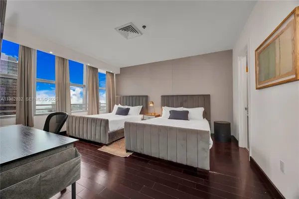 a bedroom with bed and wooden floor