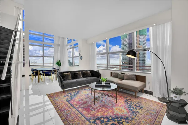 a living room with furniture fireplace and rug