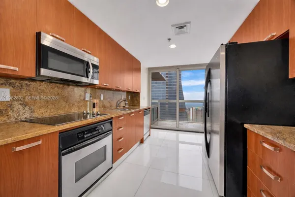 a kitchen with stainless steel appliances granite countertop a stove and a microwave