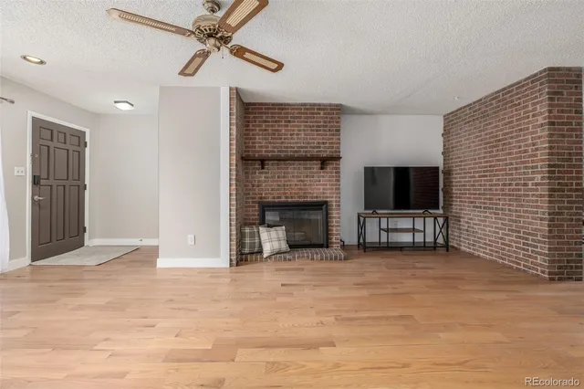 a view of a livingroom with a fireplace and a window