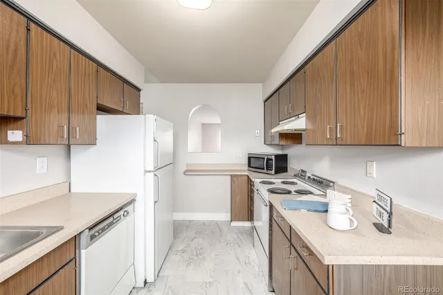 a kitchen with a sink a stove and refrigerator