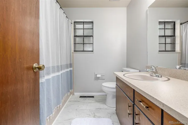 a bathroom with a sink toilet and vanity