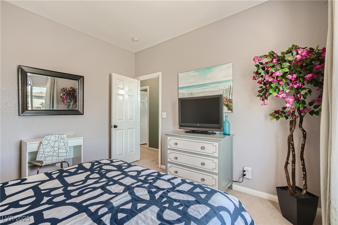 7237 West Mesa Vista Avenue Las Vegas, NV 89113 - Photo 13 of 26 Bedroom featuring light carpet and baseboards