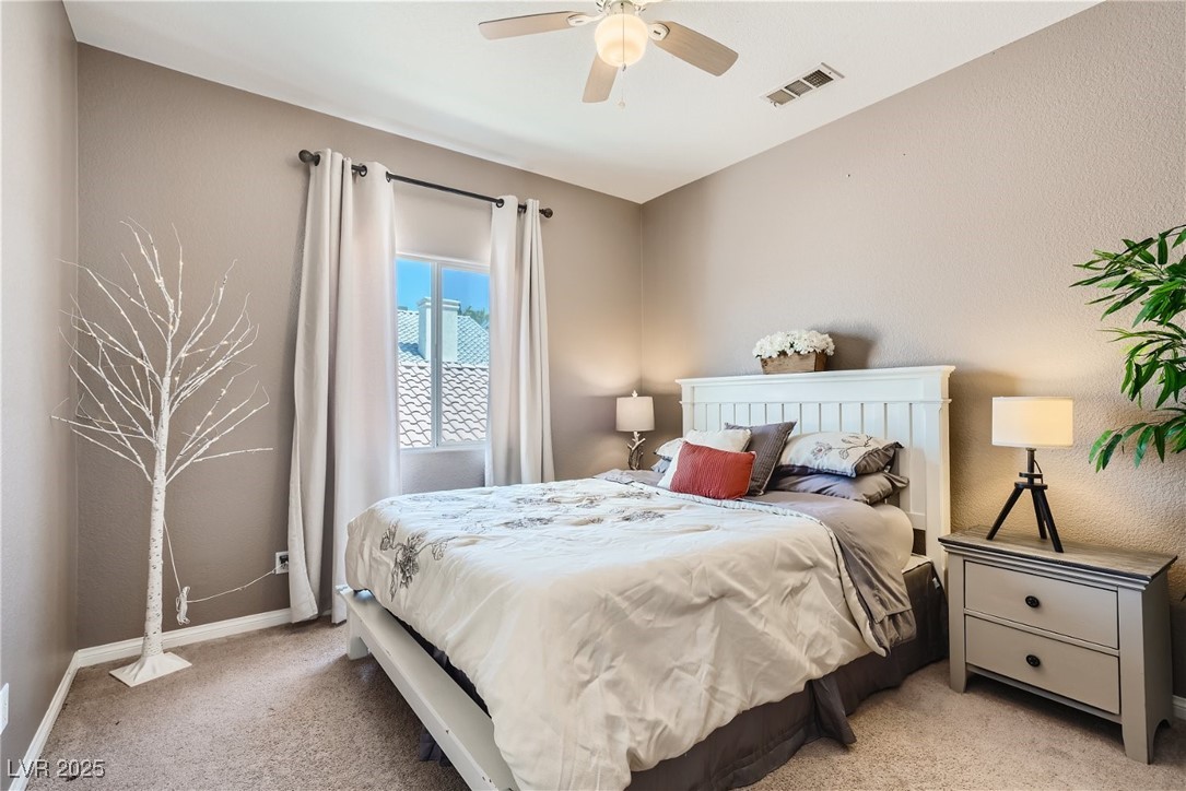 7237 West Mesa Vista Avenue Las Vegas, NV 89113 - Photo 14 of 26 Bedroom with light carpet and ceiling fan