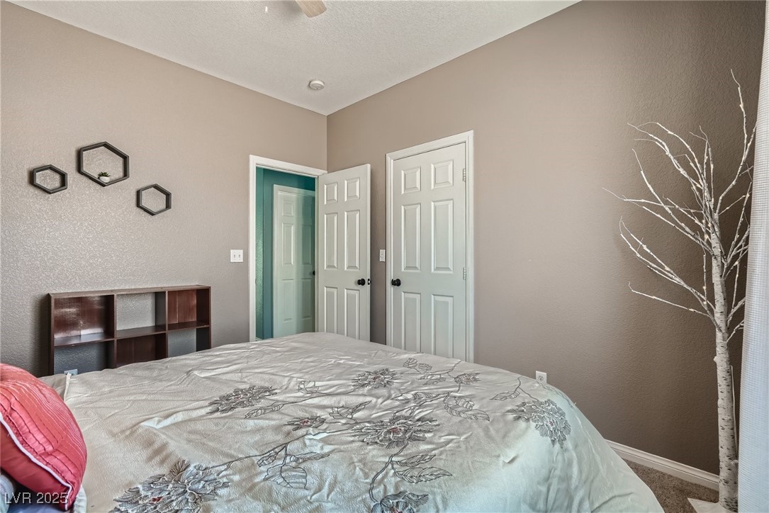 7237 West Mesa Vista Avenue Las Vegas, NV 89113 - Photo 15 of 26 Carpeted bedroom featuring a textured wall and a c