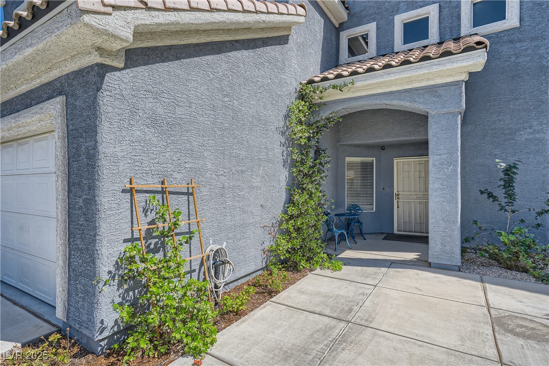 7237 West Mesa Vista Avenue Las Vegas, NV 89113 - Photo 2 of 26 View of side of home with stucco siding, a tiled r