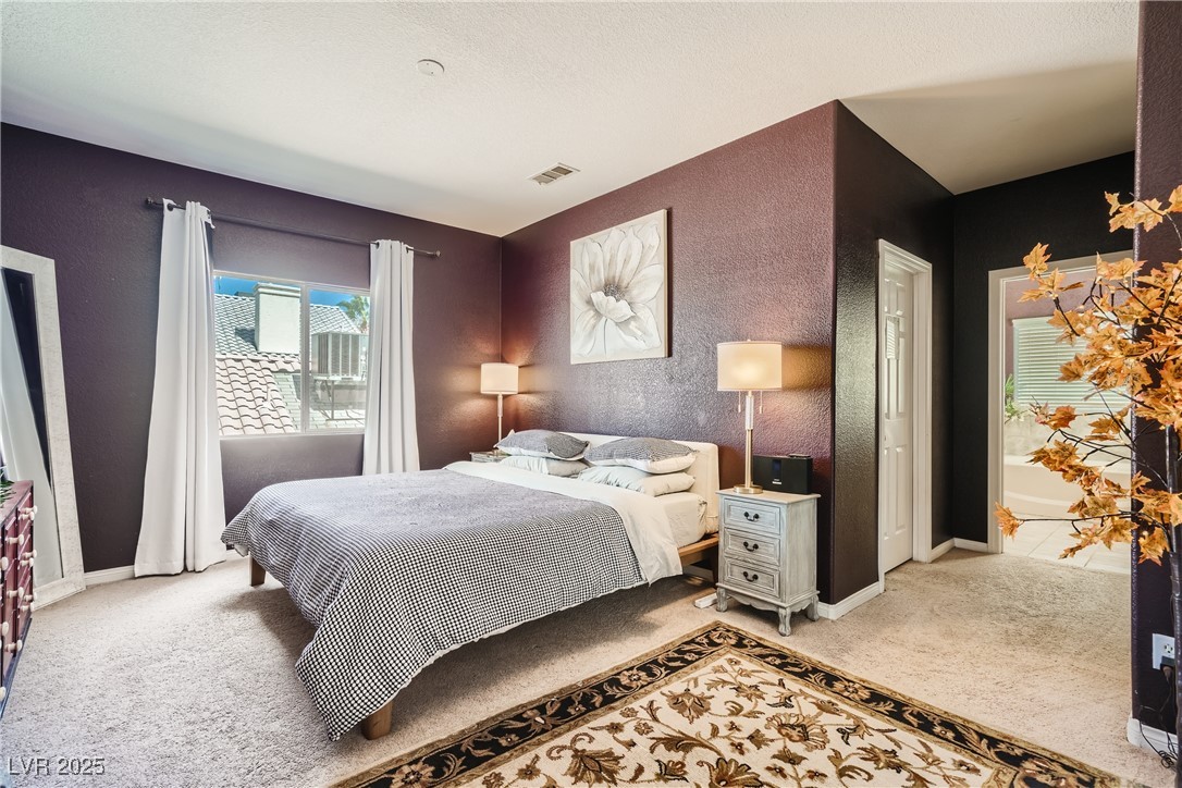 7237 West Mesa Vista Avenue Las Vegas, NV 89113 - Photo 9 of 26 Bedroom with light carpet and a textured wall