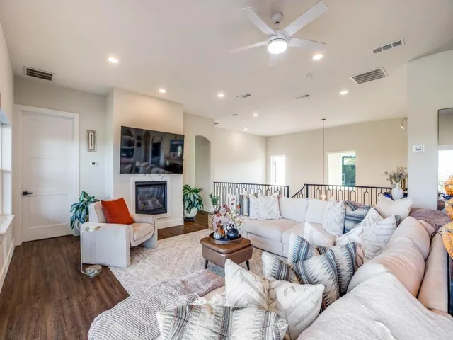 a living room with furniture fireplace and a large window