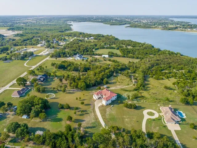 an aerial view of ocean residential house with outdoor space and trees around