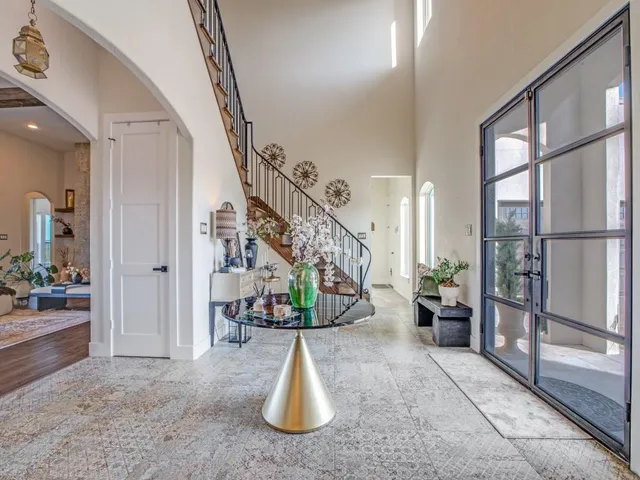 a living room with fireplace furniture and a large window