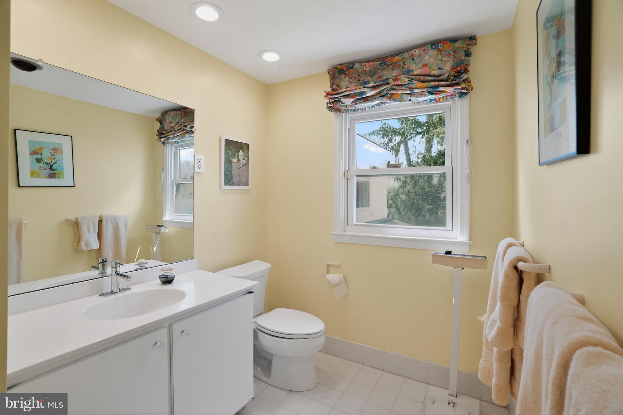 211 Fairfield Drive Wallingford, PA 19086 - Photo 18 of 29 a bathroom with a toilet sink and mirror
