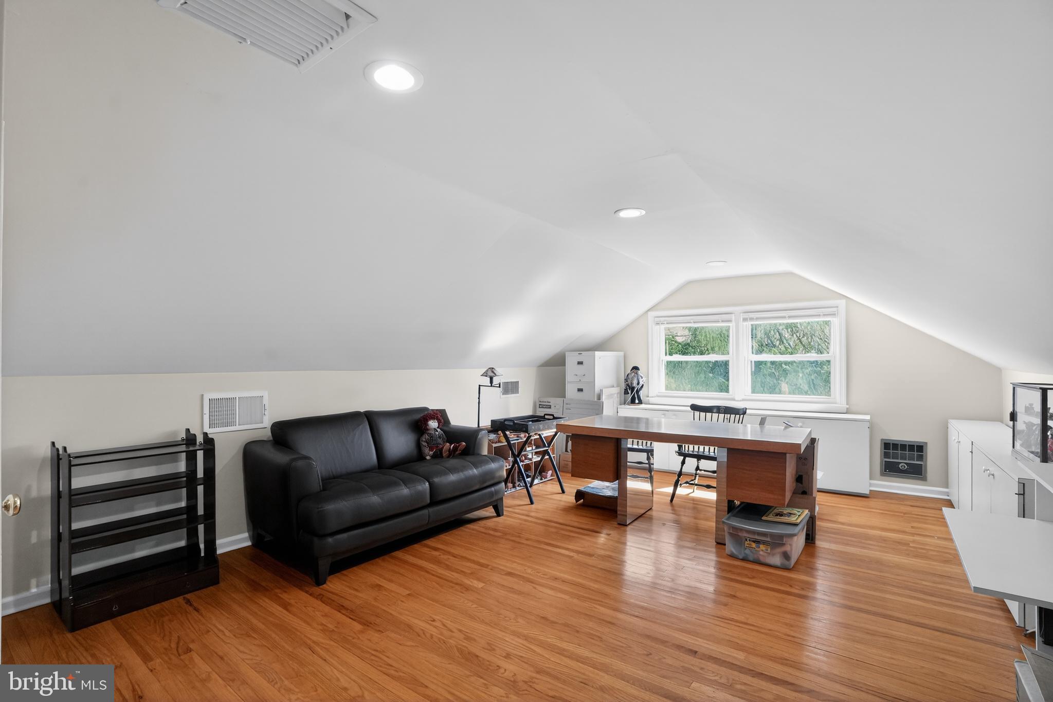 211 Fairfield Drive Wallingford, PA 19086 - Photo 19 of 29 a living room with furniture a wooden floor and a window