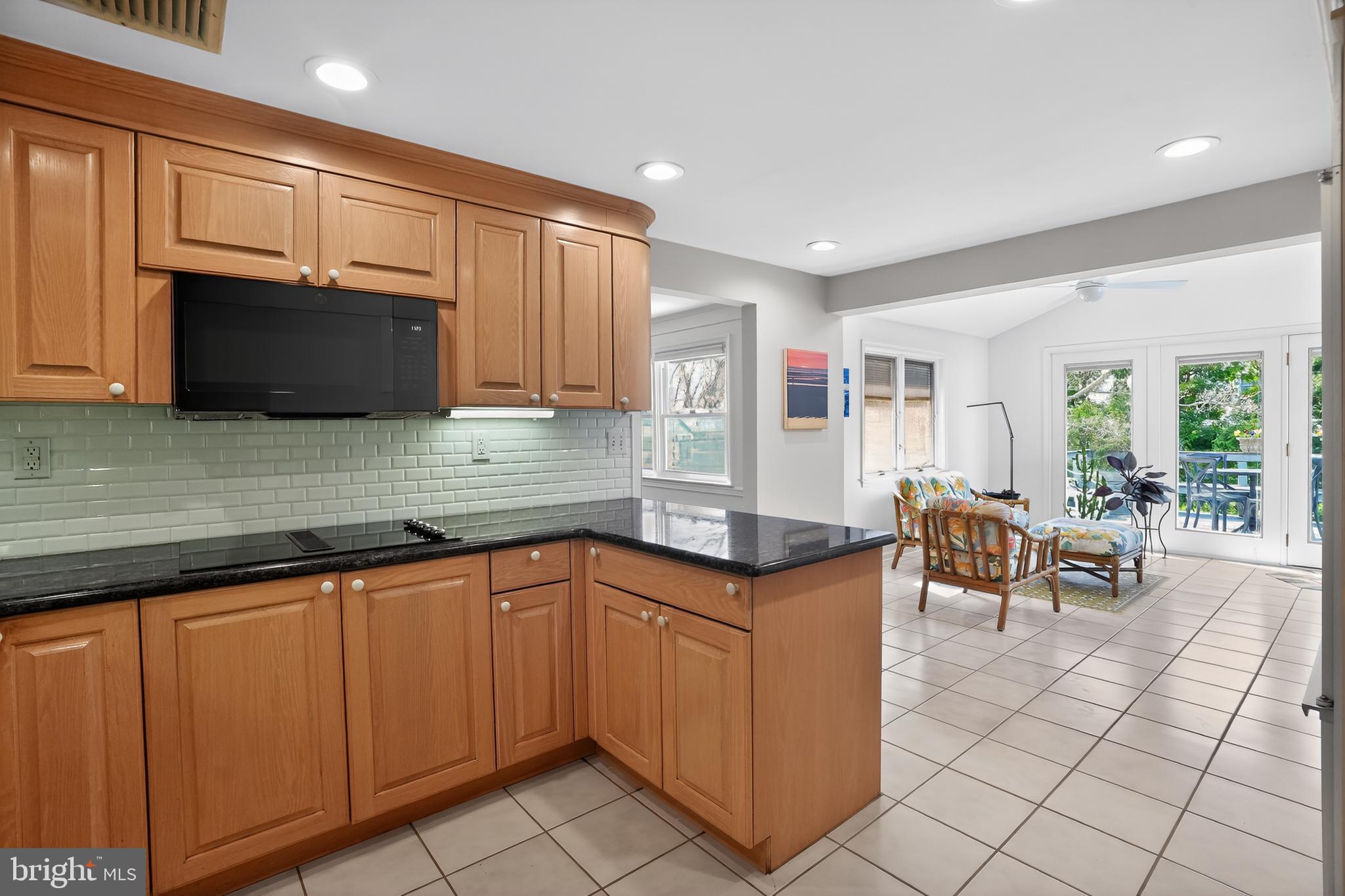 211 Fairfield Drive Wallingford, PA 19086 - Photo 8 of 29 a kitchen with stainless steel appliances granite countertop a stove a sink and a microwave