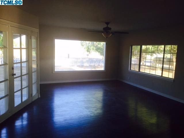 355 South Cornucopia Road Exeter, CA 93221 - Photo 10 of 26 a view of an empty room with wooden floor and a window