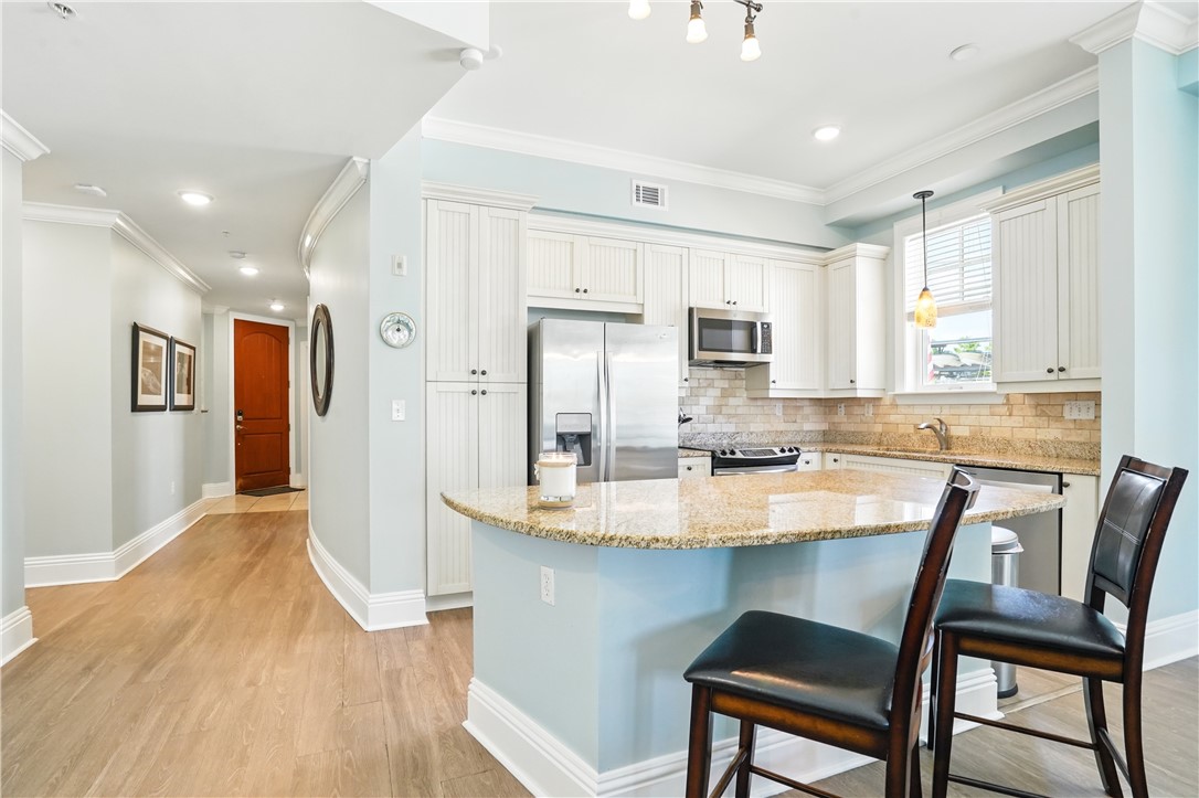 20 Waterfront Drive, Unit 121 St. Simons Island, GA 31522 - Photo 4 of 42 Kitchen and living area flows well with awesome views of the marina.