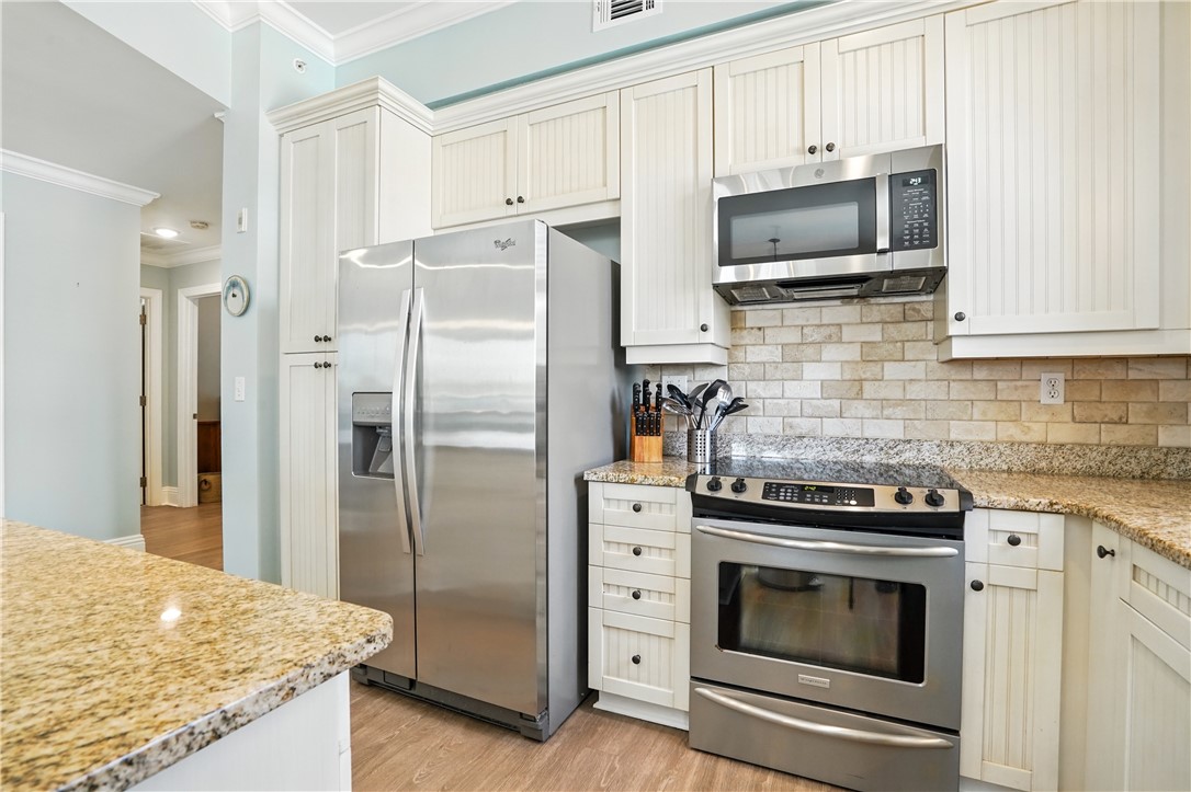 20 Waterfront Drive, Unit 121 St. Simons Island, GA 31522 - Photo 5 of 42 Plenty of cabinetry with an additional abundance in the spacious island.