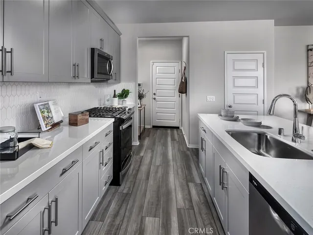 a kitchen with a sink cabinets and stainless steel appliances