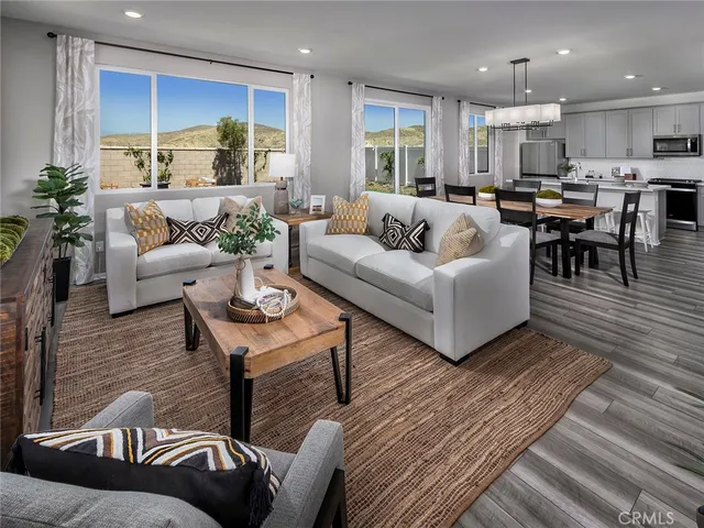 a living room with furniture kitchen and a table