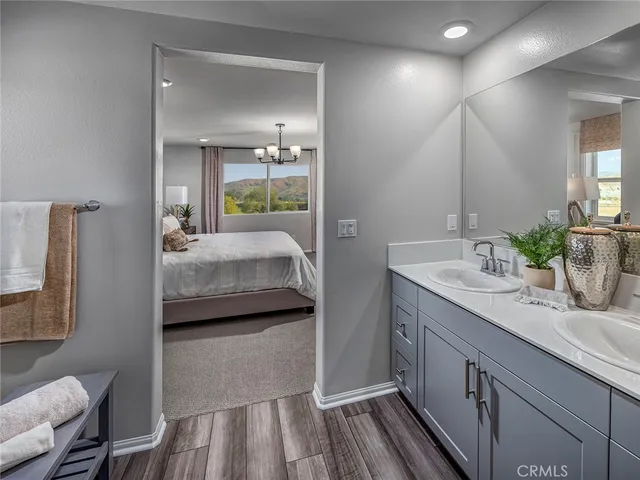 a en suite bathroom with a granite countertop sink and a mirror