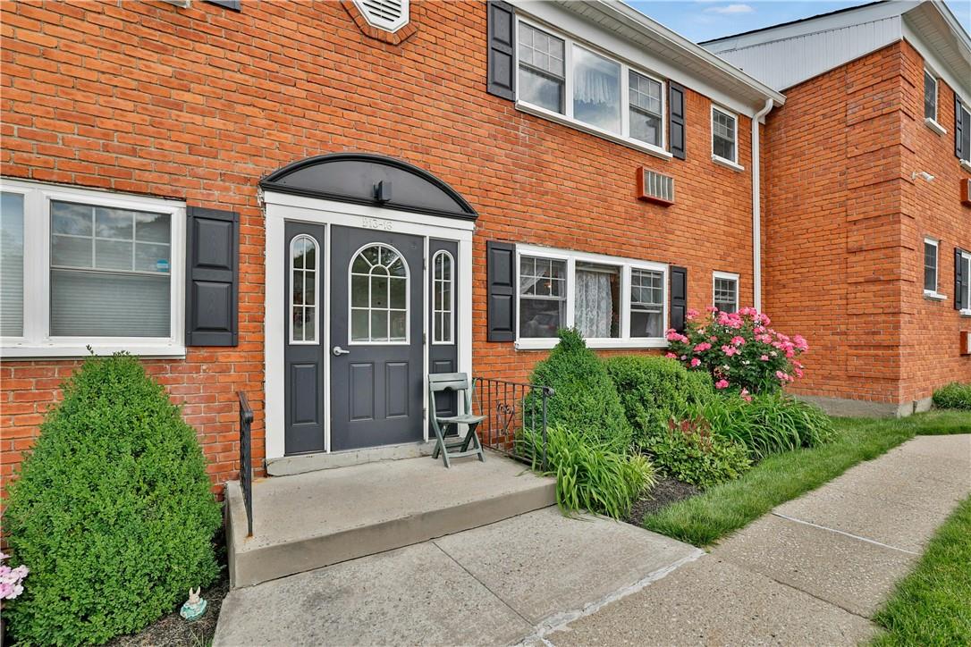 1879 Crompond Road, Unit D13 Peekskill, NY 10566 - Photo 1 of 1 a front view of a house with a garden