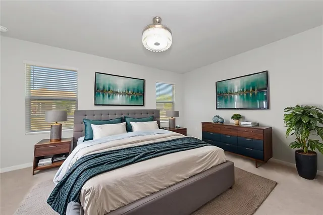 a bedroom with bed and a chandelier