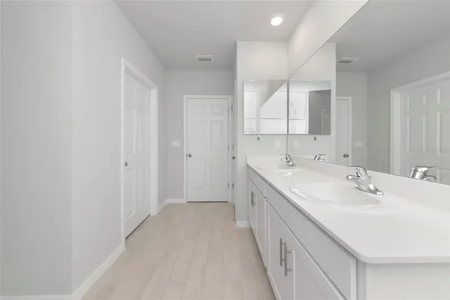 a bathroom with a sink a mirror and a bathtub