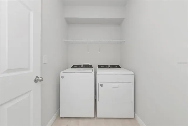 a view of an empty room with closet and a window