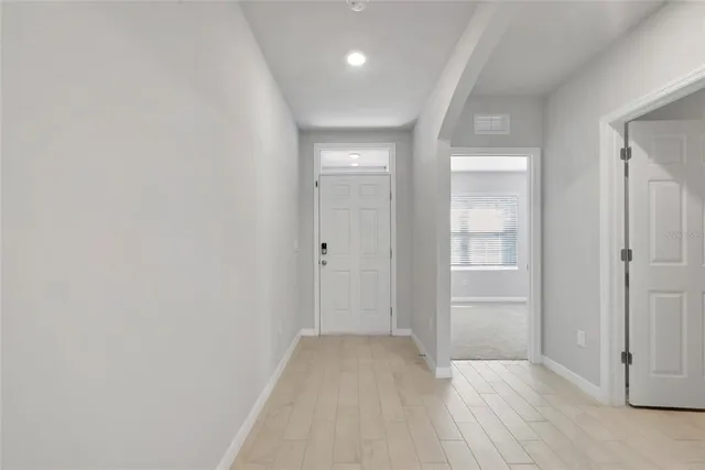 wooden floor in an empty room with a gallery