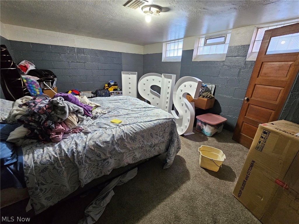 13513 Cedar Road Cleveland, OH 44118 - Photo 29 of 36 Bedroom featuring carpet floors and a textured ceiling
